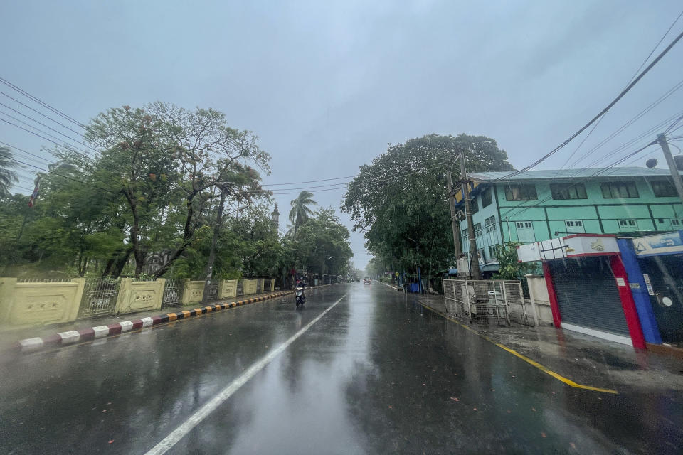 A local rides motorbike on nearly empty road before Cyclone Mocha hits in Sittwe, Rakhine State, Sunday, May 14, 2023. Bangladesh and Myanmar were bracing Sunday as the extremely severe cyclone was set to hit their coastal areas, and authorities told thousands of people in both countries to seek shelter. (AP Photo)