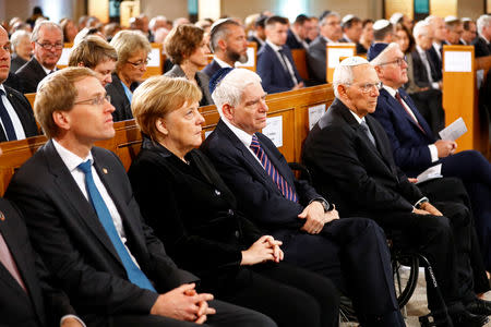 German Chancellor Angela Merkel, President Frank-Walter Steinmeier, President of Germany's lower house of parliament Bundestag Wolfgang Schaeuble and President of the Central Council of Jews in Germany Josef Schuster take part in a ceremony to mark the 80th anniversary of Kristallnacht, also known as Night of Broken Glass, at Rykestrasse Synagogue, in Berlin, Germany, November 9, 2018. REUTERS/Fabrizio Bensch