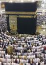 Muslims circle the Kaaba and attend the night-time daily prayer "Al Isha prayer" during their Umrah Mawlid al-Nabawi pilgrimage, at the Grand Mosque in the holy city of Mecca January 13, 2014. Muslims mark Eid Mawlid al-Nabawi, or the birth of Prophet Mohammad on Tuesday. REUTERS/Amr Abdallah Dalsh (SAUDI ARABIA - Tags: RELIGION SOCIETY)