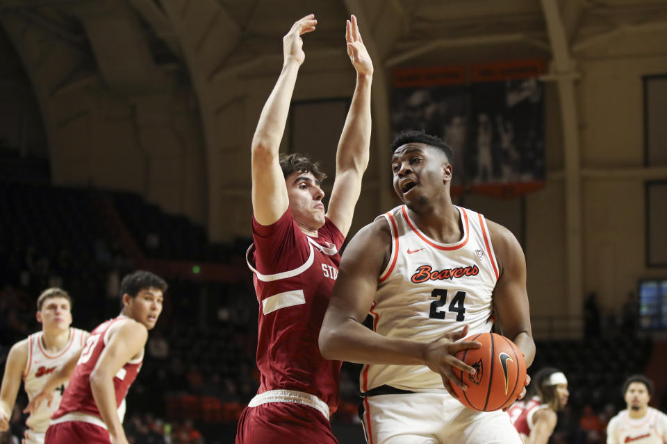 Oregon State center KC Ibekwe (24) drives to the basket as Stanford forward Maxime Raynaud (42) defends during the first half of an NCAA college basketball game Thursday, Jan. 11, 2024, in Corvallis, Ore. (AP Photo/Amanda Loman)