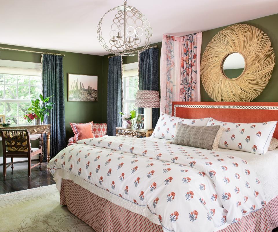 Green walls, orange headboard, lamp