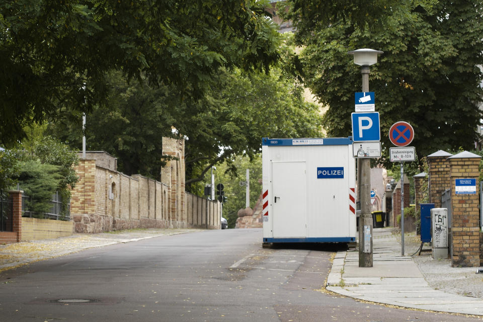 FILE - In this Monday, July 20, 2020 file photo, a container used by police is seen in front of the synagogue in Halle, Germany where a gunman made an attack on Yom Kippur 2019. Millions have be provided to enhance the security of Jewish sites, but some say it is still not enough and also doesn't tackle the question whether Jewish life can ever be normal and safe in Germany. (AP Photo/Markus Schreiber)