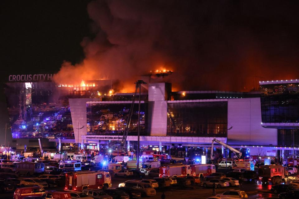 Emergency services vehicles are seen outside the burning Crocus City Hall concert hall following the shooting incident in Krasnogorsk, outside Moscow on March 22, 2024.