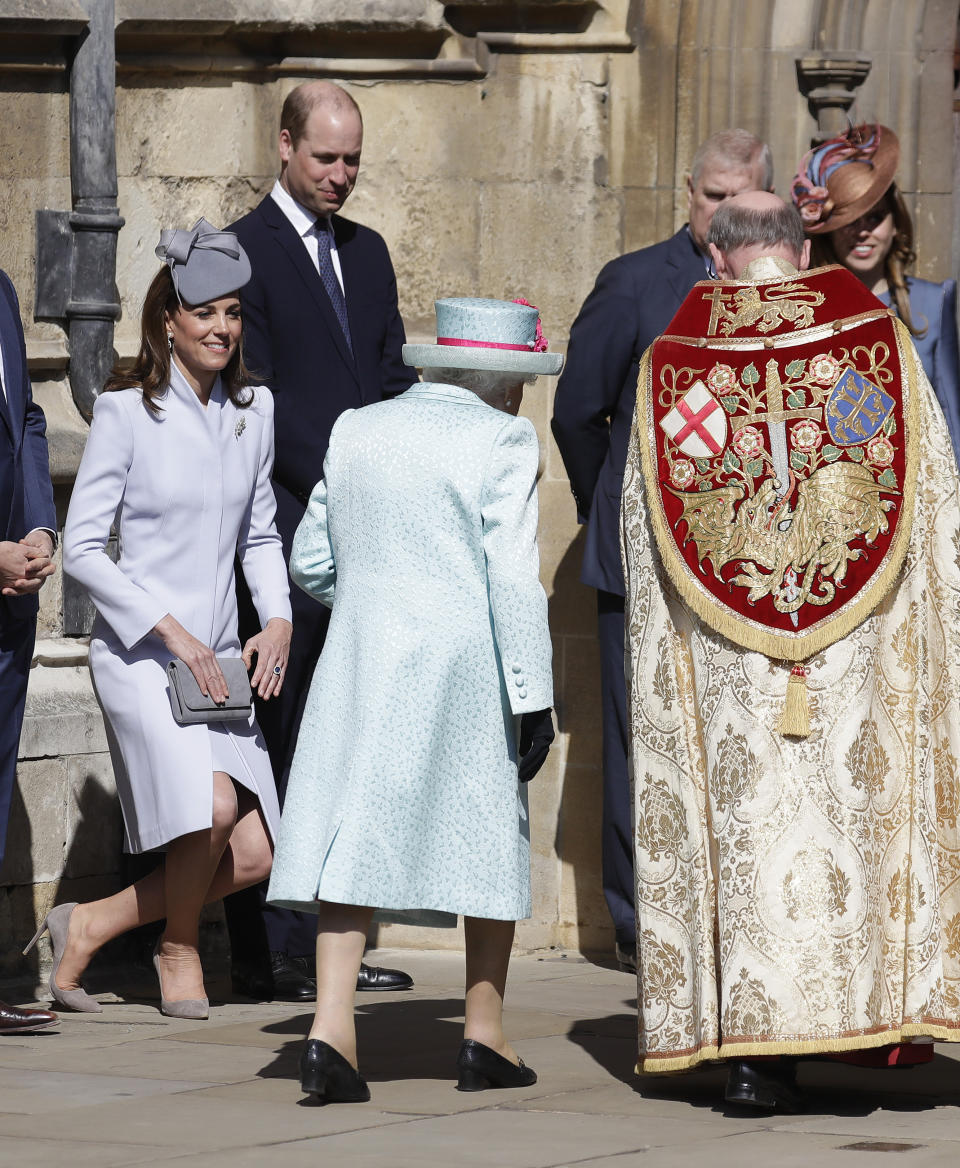 Britain's Kate, The Duchess of Cambridge curtsies as Britain's Queen Elizabeth II arrives to attend the Easter Mattins Service at St. George's Chapel, at Windsor Castle in England Sunday, April 21, 2019. (AP Photo/Kirsty Wigglesworth, pool)