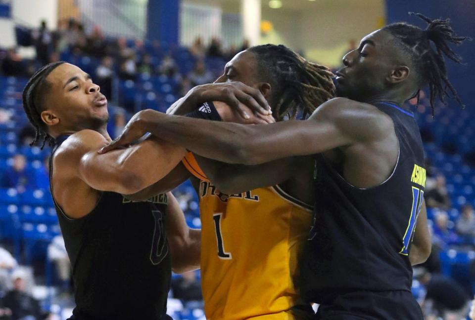 Delaware's Jameer Nelson, Jr. (left) and Ebby Asamoah converge on Drexel's Lamar Oden, Jr. as the Hens make a last-minute comeback bid in the second half of Delaware's 58-54 loss at the Bob Carpenter Center, Wednesday, Feb. 8, 2023.