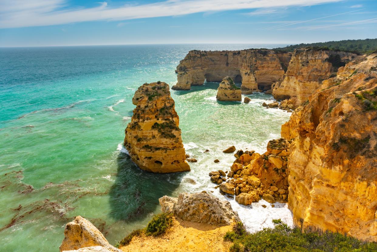 holiday  Natural caves and beach, Algarve Portugal. Rock cliff arches of Seven Hanging Valleys and turquoise sea water on coast of Portugal in Algarve region