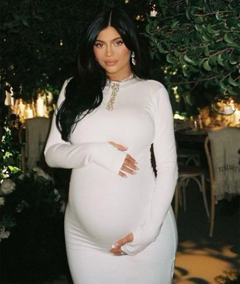 Kylie Jenner wearing a white dress pregnant