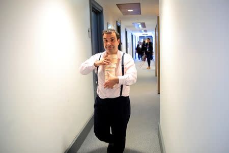 French deputy Richard Ramos carries boxes of non-pasteurized French Camembert cheese at the National Assembly in Paris, France, March 13, 2019. REUTERS/Gonzalo Fuentes