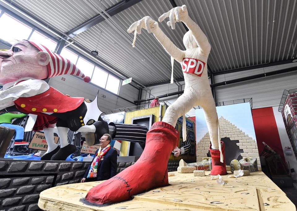 A satiric carnival float depicting the German social Democratic Party as a mummy is shown during a preview in a hall in Cologne, Germany, Tuesday, Feb. 18, 2020. The traditional carnival parades on Rosemonday make fun of politics and are watched by hundreds of thousands in the streets of Cologne, Duesseldorf and Mainz. (AP Photo/Martin Meissner)