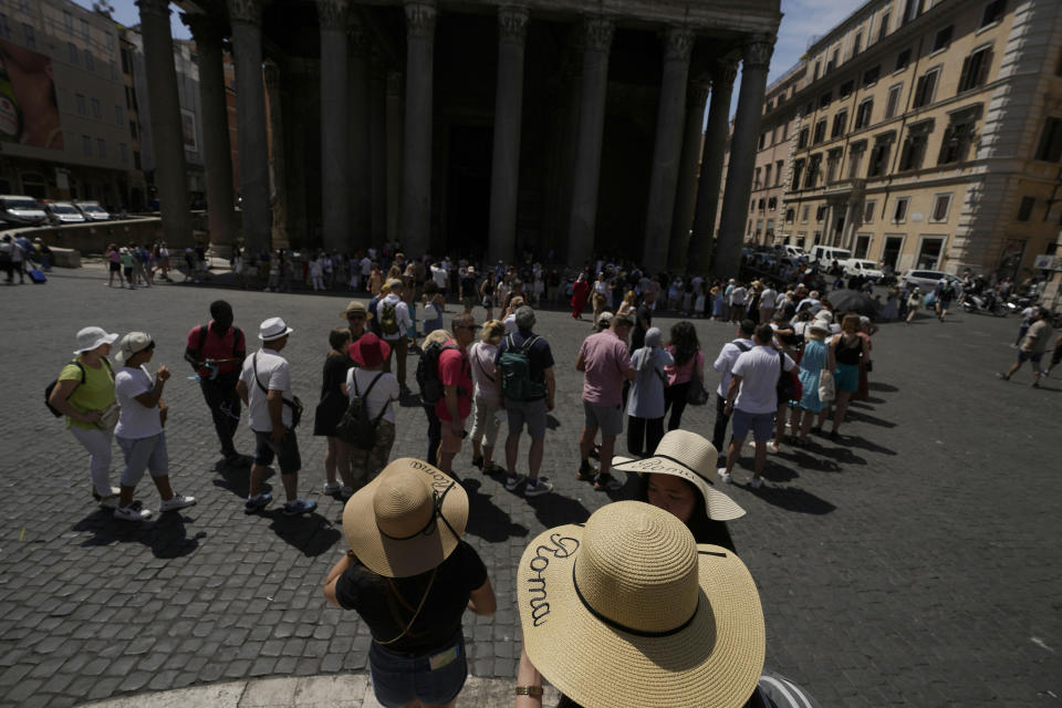 Tourists queue to visit Rome's Pantheon Friday, June 17, 2022. Summer travel is underway across the globe, but a full recovery from two years of coronavirus could last as long as the pandemic itself. In Italy, tourists — especially from the U.S. — returned this year in droves. (AP Photo/Alessandra Tarantino)