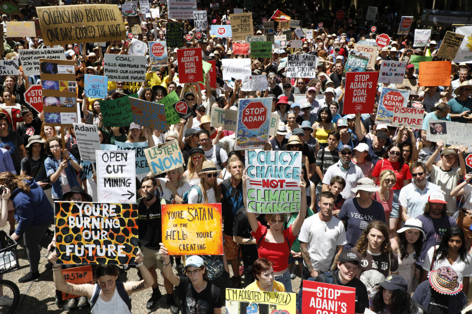 Protesters are seen marching through Sydney in protest of Adani’s Queensland coal mine project in Sydney, Saturday, December 8, 2018. Image: AAP