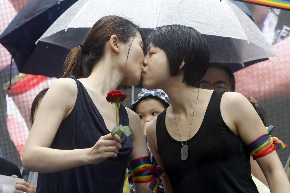 Same-sex marriage supporters kiss outside the Legislative Yuan Friday, May 17, 2019, in Taipei, Taiwan after the legislature passed a law allowing same-sex marriage in a first for Asia. (AP Photo/Chiang Ying-ying)