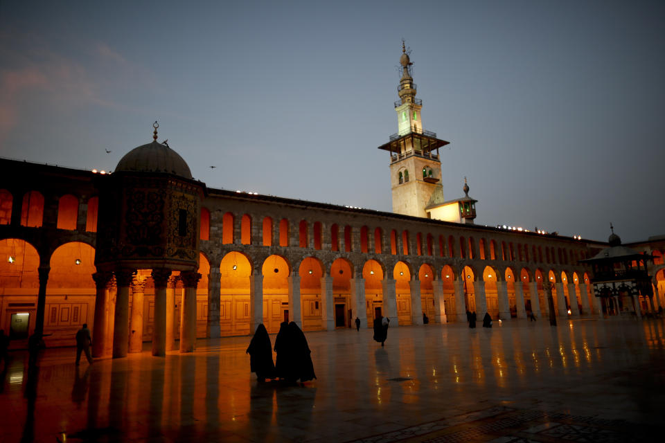 Muslim women walk in the courtyard of the 7th century Umayyad Mosque in Damascus, Syria, Wednesday, Oct. 3, 2018. (AP Photo/Hassan Ammar)