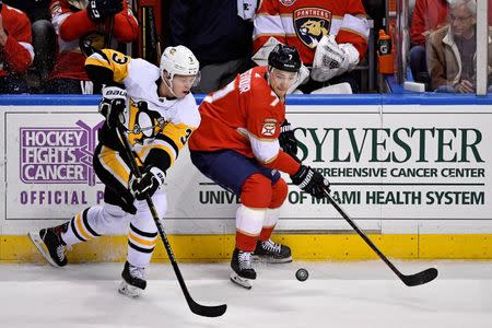 Feb 7, 2019; Sunrise, FL, USA; Pittsburgh Penguins defenseman Olli Maatta (3) and Florida Panthers center Colton Sceviour (7) chase a loose puck during the third period at BB&T Center. Mandatory Credit: Jasen Vinlove-USA TODAY Sports