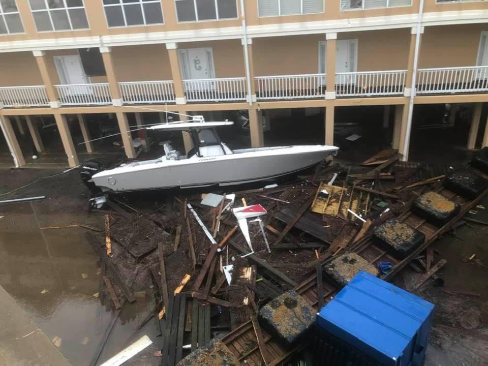 A boat and debris were washed into a building in Orange Beach on Wednesday.