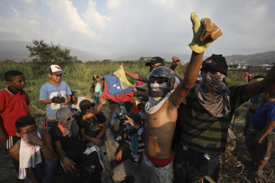 Venezuelan migrants near the Simon Bolivar International Bridge plead for people to support them with food and water so they can continue protesting in La Parada near Cucuta, Colombia, Sunday, Feb. 24, 2019, on the border with Venezuela. A U.S.-backed drive to deliver foreign aid to Venezuela on Saturday met strong resistance as troops loyal to President Nicolas Maduro blocked the convoys at the border and fired tear gas on protesters. (AP Photo/Fernando Vergara)