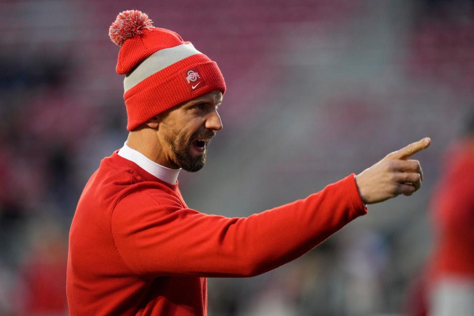 Oct 28, 2023; Madison, Wisconsin, USA; Ohio State Buckeyes assistant coach James Laurinaitis warms up his team prior to the NCAA football game against the Wisconsin Badgers at Camp Randall Stadium.