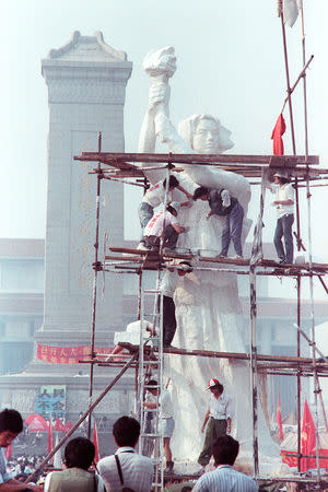 FILE PHOTO: Student activists work on what they call the "Goddess of Democracy" at a campus near Tiananmen Square, Beijing, China May 29, 1989. REUTERS/Ed Nachtrieb/File Photo