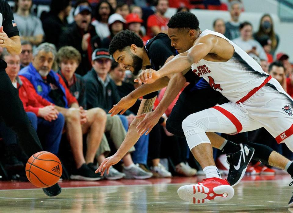 N.C. State’s Casey Morsell and Saint Louis’ Michael Meadows Jr. dive for a loose ball during the second half of the Wolfpack’s 82-70 win on Wednesday, Dec. 20, 2023, at PNC Arena in Raleigh, N.C.