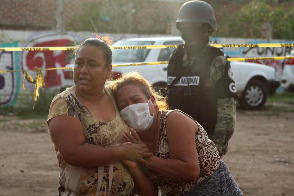 A woman reacts outside the drug rehabilitation centre where dozens were killed by gunmen (REUTERS)