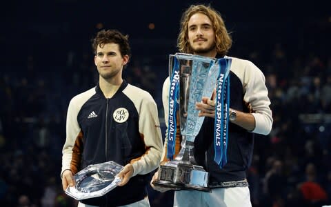 Greece's Stefanos Tsitsipas celebrates winning the ATP Finals with the trophy with runner-up Austria's Dominic Thiem - Credit: Reuters