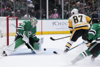 Dallas Stars goaltender Jake Oettinger (29) defends against as shot by Pittsburgh Penguins center Sidney Crosby (87) in the second period of an NHL hockey game, Thursday, March 23, 2023, in Dallas. (AP Photo/Tony Gutierrez)