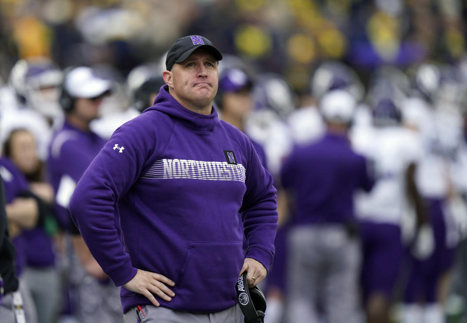 FILE - Northwestern coach Pat Fitzgerald stands on the sideline during the first half of the team's NCAA college football game against Michigan, Oct. 23, 2021, in Ann Arbor, Mich. A former Wildcats football player filed the first lawsuit against Fitzgerald and members of the school’s leadership Tuesday, July 18, 2023, seeking damages stemming from a hazing scandal that cost the former football coach his job. (AP Photo/Carlos Osorio, File)