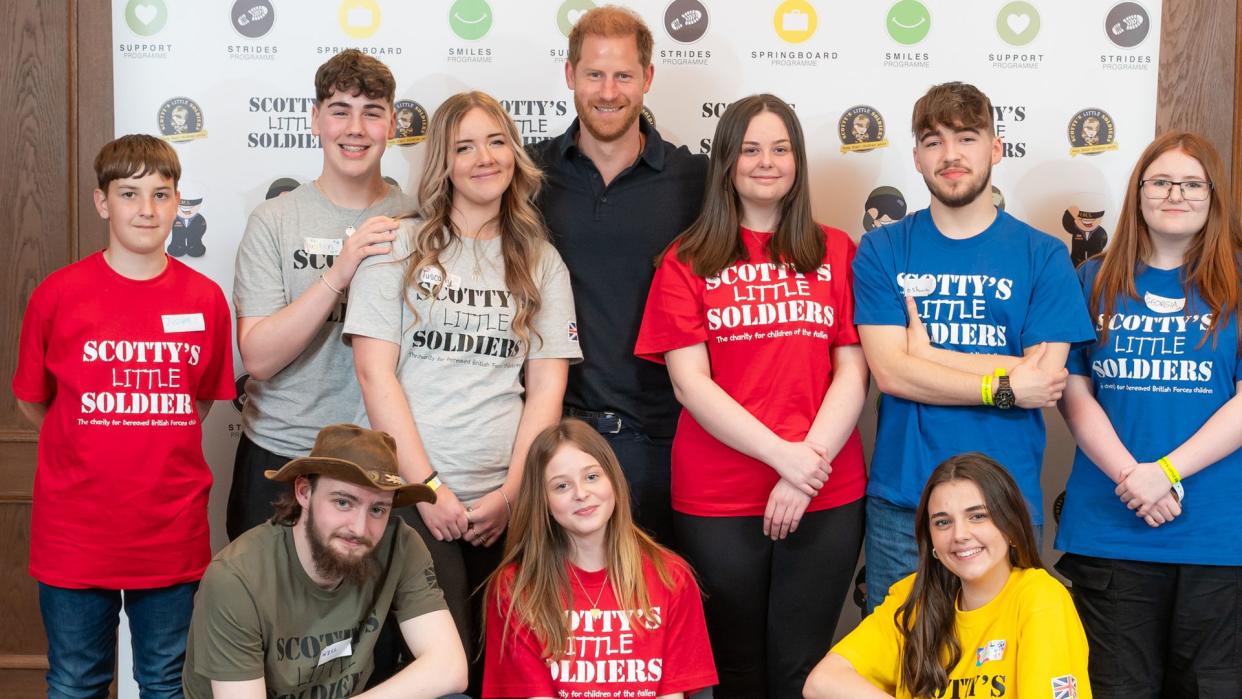 Prince Harry with a group of young people in Scotty's Little Soldiers shirts
