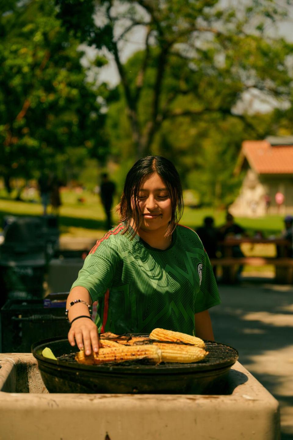 Sereidy Gonzalez grills corn at Elysian Park.