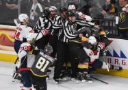 May 30, 2018; Las Vegas, NV, USA; Officials try to break up a scrum as Vegas Golden Knights defenseman Colin Miller (6) tackles Washington Capitals right wing Tom Wilson (43) in the third period in game two of the 2018 Stanley Cup Final at T-Mobile Arena. Stephen R. Sylvanie-USA TODAY Sports