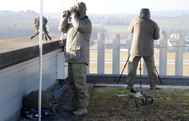 Two marksmen of the Police of the Canton of Zurich stand on an observation post at the airport in Zurich