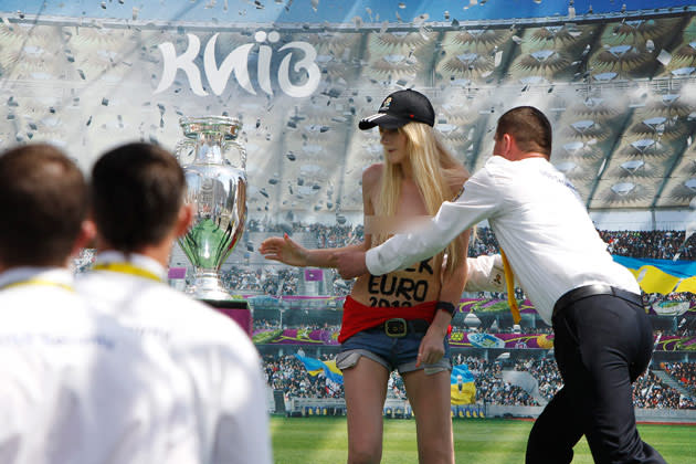 Topless activists from a Ukrainian women's rights group staged a second attack on the Euro 2012 soccer trophy on Monday, grabbing it while it was on public display in the southeast of Ukraine before being seized themselves by police.