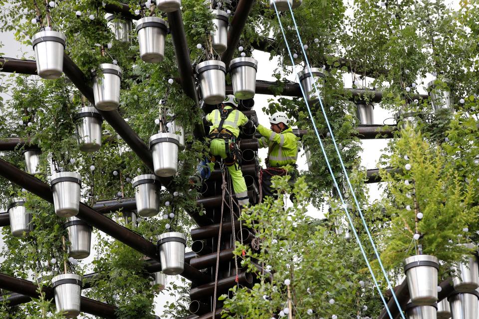 A team of workers add the final parts to the Queen's Green Canopy ahead of the Platinum Jubilee (Getty Images)