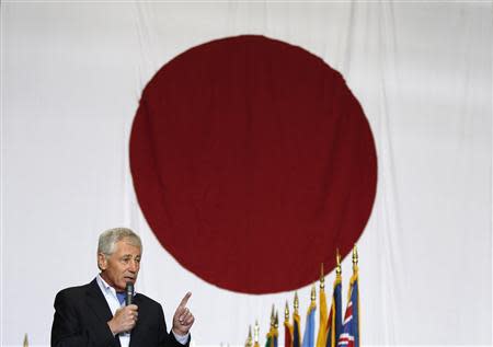 U.S. Defense Secretary Chuck Hagel speaks to U.S. and Japan military personnel stationed at Yokota Air Base on the outskirts of Tokyo April 5, 2014. Hagel moved on Saturday to reassure Japan of America's commitment to its security, as Russia's annexation of Crimea raises eyebrows in a region facing its own territorial disputes with an increasingly assertive China. REUTERS/Toru Hanai