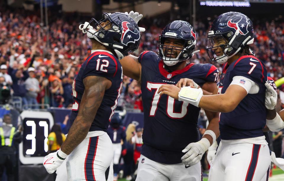 Houston Texans wide receiver Nico Collins (12) celebrates his touchdown reception with center Juice Scruggs (70) and quarterback C.J. Stroud (7) against the Denver Broncos in the second half at NRG Stadium.