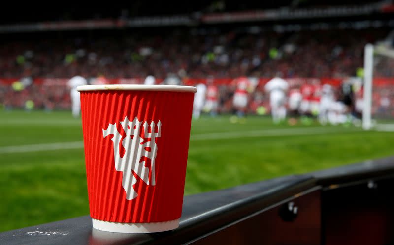 FILE PHOTO: A Manchester United branded coffee cup sits on a trackside LED advertising board during the Manchester United v Swansea City Premier League football match