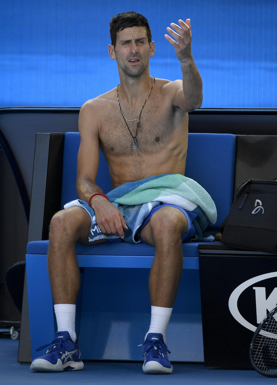 Serbia's Novak Djokovic gestures during a break in his third round match against Canada's Denis Shapovalov at the Australian Open tennis championships in Melbourne, Australia, Saturday, Jan. 19, 2019. (AP Photo/Andy Brownbill)