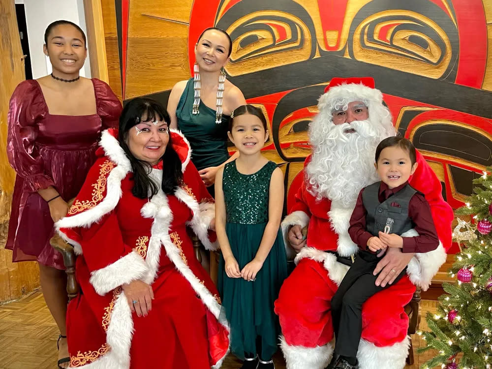 Phoenix Johnson (Tlingit and Haida) Top second from left, and her family pose with Indian Santa and Ms. Indian Claus at the Annual Holiday Party at Daybreak Star Indian Cultural Center in Seattle, WA. Courtesy of Phoenix Johnson