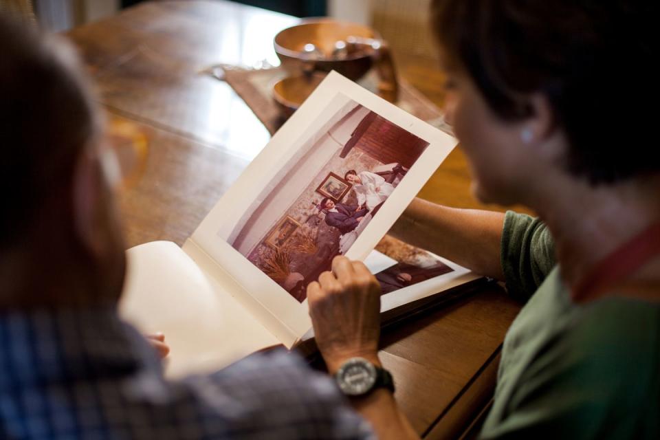 first point of view of a senior man looking at a old wedding photo album