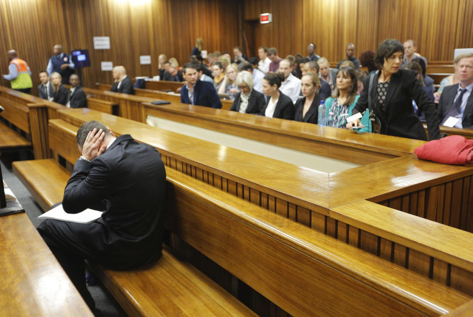 Oscar Pistorius sits in the dock ahead of the second day of the trial of the Olympic and Paralympic track star at the North Gauteng High Court in Pretoria, March 4, 2014. REUTERS/Kim Ludbrook/Pool (SOUTH AFRICA - Tags: SPORT ATHLETICS CRIME LAW TPX IMAGES OF THE DAY)