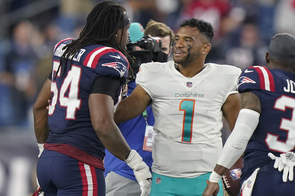 Miami Dolphins quarterback Tua Tagovailoa (1) talks with New England Patriots outside linebacker Dont'a Hightower (54) after an NFL football game, Sunday, Sept. 12, 2021, in Foxborough, Mass. (AP Photo/Steven Senne)