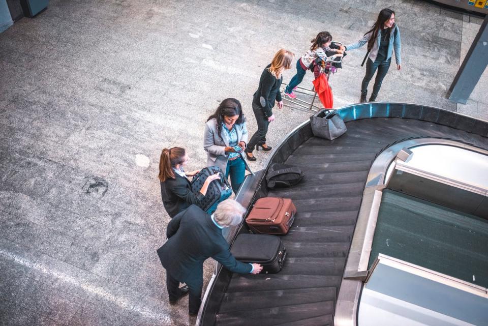 Passengers wait for luggage at the airport (Getty Images)