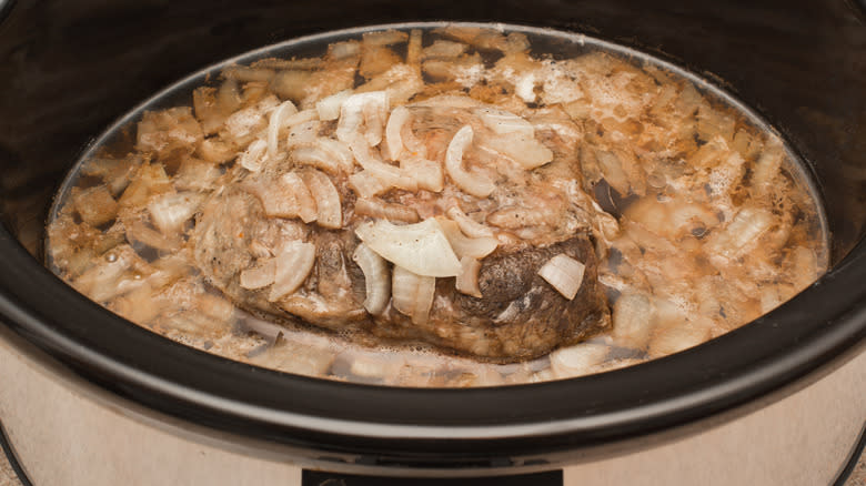 Meat in slow cooker with onions