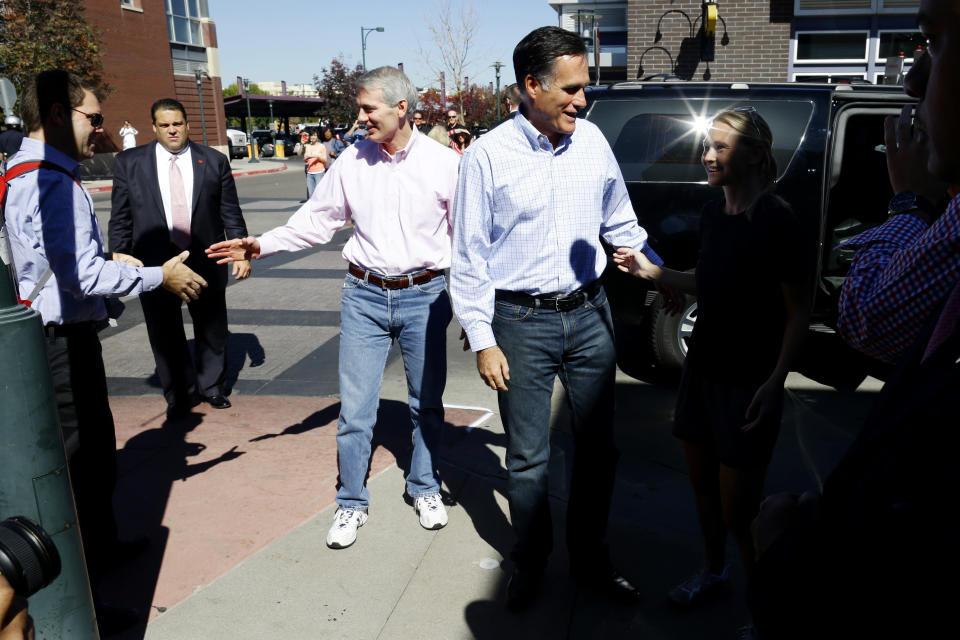 Republican presidential candidate, former Massachusetts Gov. Mitt Romney and Sen. Rob Portman, R-Ohio, greet members of the public after they made an unscheduled stop at a Chipotle restaurant in Denver, Tuesday, Oct. 2, 2012. (AP Photo/Charles Dharapak)