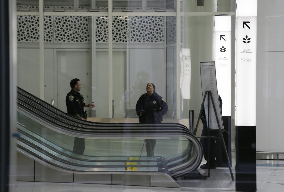 San Francisco Police officers stand watch in the lower level of the Salesforce Transit Center following its closure Tuesday, Sept. 25, 2018, in San Francisco. San Francisco officials shut down the city's celebrated new $2.2 billion transit terminal Tuesday after discovering a crack in a support beam under the center's public roof garden. Coined the "Grand Central of the West," the Salesforce Transit Center opened in August near the heart of downtown after nearly a decade of construction. It was expected to accommodate 100,000 passengers each weekday, and up to 45 million people a year. (AP Photo/Eric Risberg)