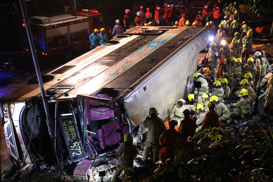 <p>Firemen hurry to try to remove injured passengers from a double-decker lying on its side in Hong Kong, Saturday, Feb. 10, 2018. (Photo: Apple Daily via AP) </p>