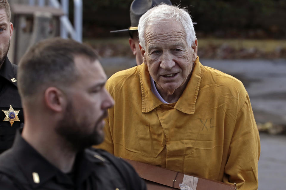 Former Penn State University assistant football coach Jerry Sandusky, right, leaves the Centre County Courthouse after attending a resentencing hearing on his 45-count child sexual abuse conviction Friday, Nov. 22, 2019. (AP Photo/Gene J. Puskar)