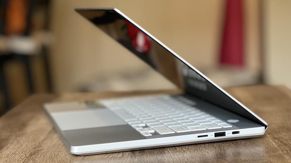 Asus ROG Zephyrus G14 gaming laptop side profile on a wooden table