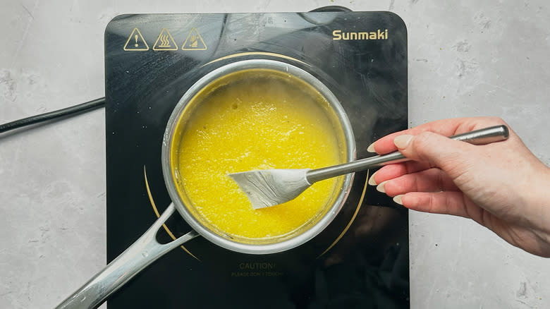 stirring polenta in a saucepan