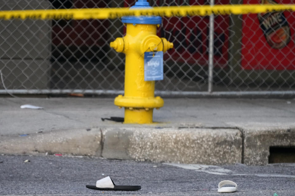 Two shower shoes are seen in the street in the Ybor City section of Tampa, Fla., after a shooting Sunday, Oct. 29, 2023. A fight between two groups turned deadly in a shooting during Halloween festivities. (AP Photo/Chris O'Meara)